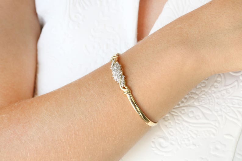 Vintage 14K gold bangle bracelet featuring 0.88tcw natural white diamond baguettes by Colombian Emerald.