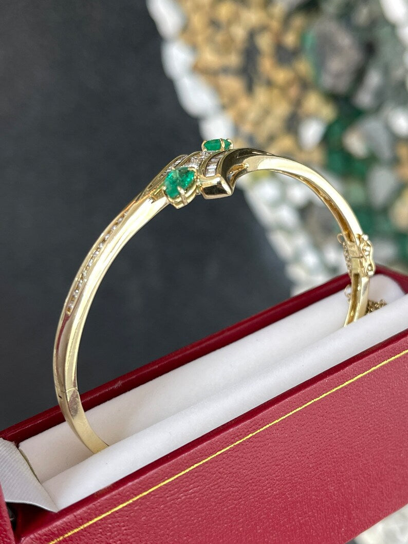 14K yellowish green emerald bangle bracelet with round cut emeralds and triple diamond accents, Colombian Emerald brand.