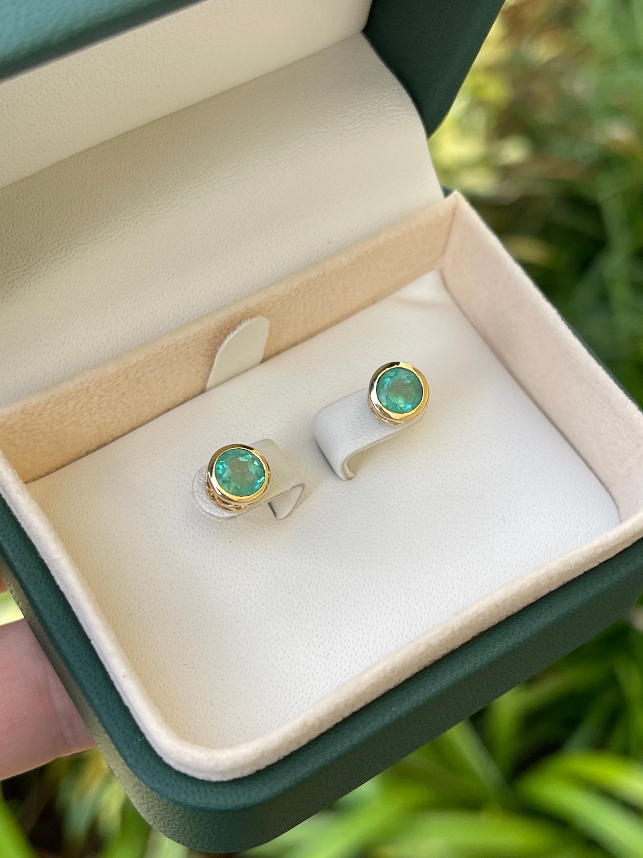 Colombian Emerald 1.60tcw 14K gold round cut natural earrings with push back closure, showcasing vibrant green emeralds.