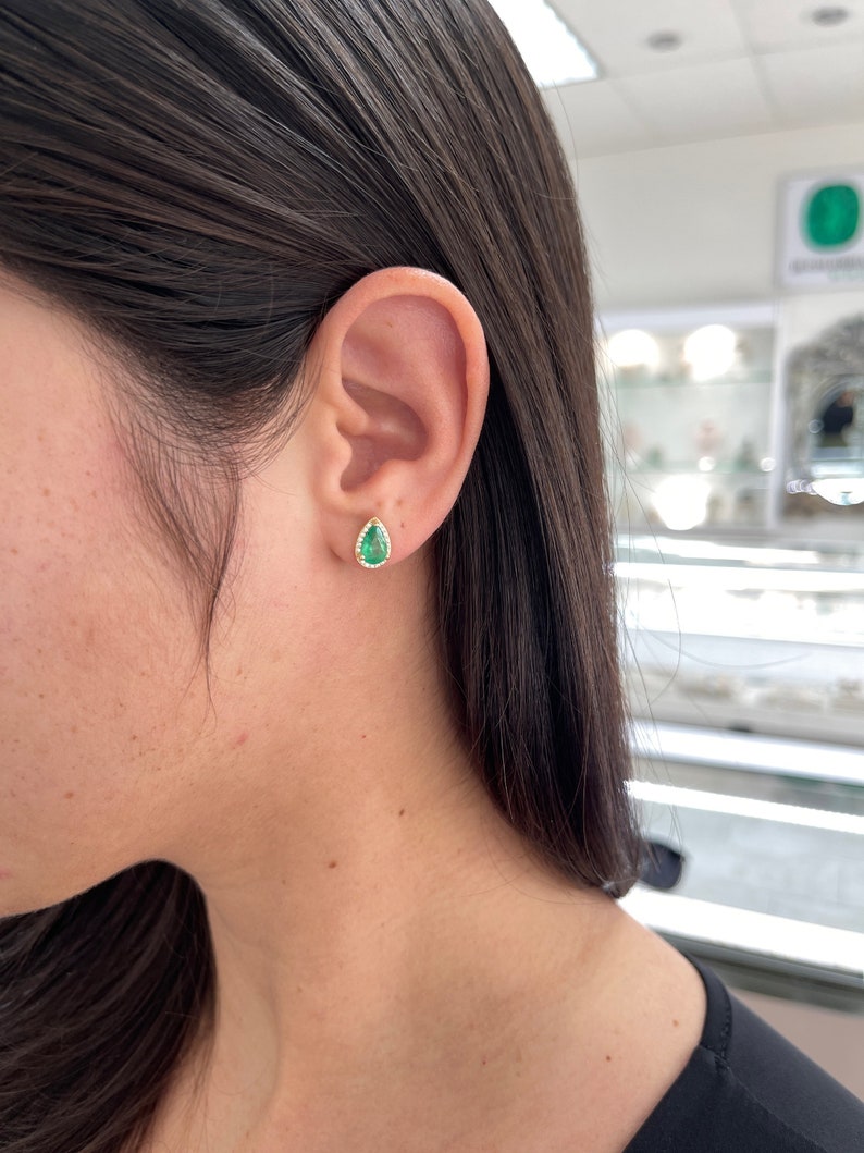 14K yellow gold teardrop emerald and diamond earrings with pave halo, featuring 1.87 tcw pear-shaped design by Colombian Emerald