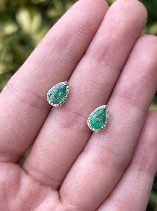 14K yellow gold teardrop earrings with emerald and diamond pave halo, featuring pear-shaped design and intricate detailing.