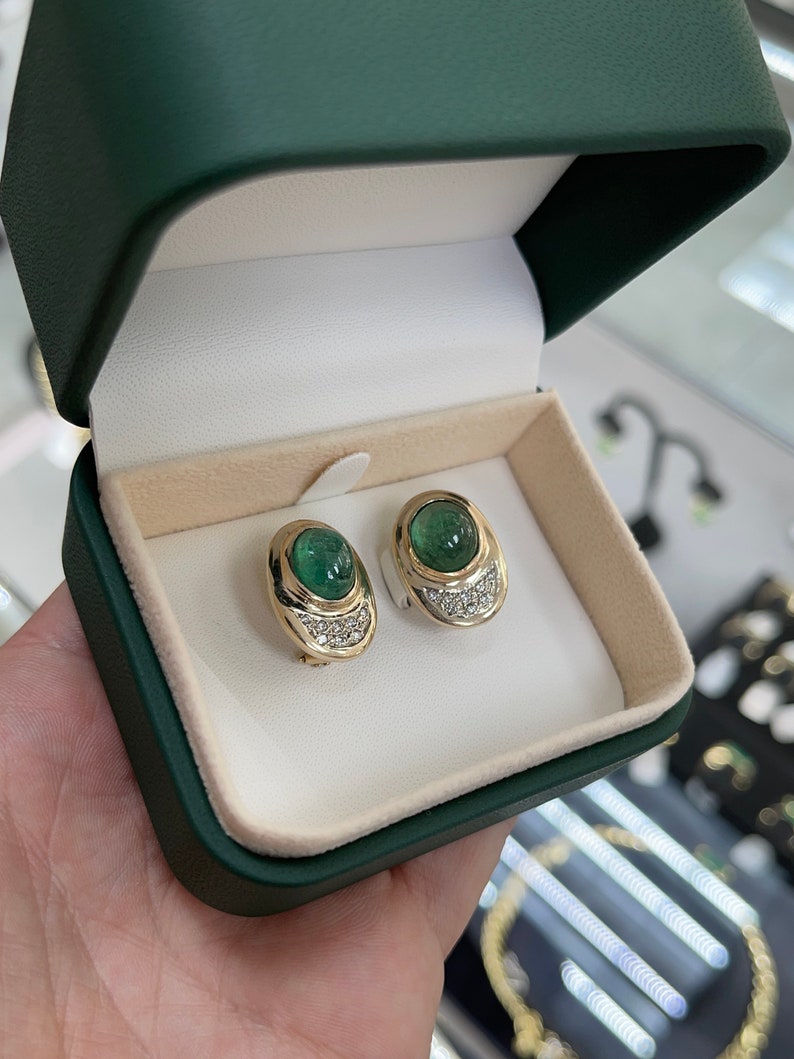 14K yellow gold clip-on earrings with emerald cabochons and diamond accents from Colombian Emerald.