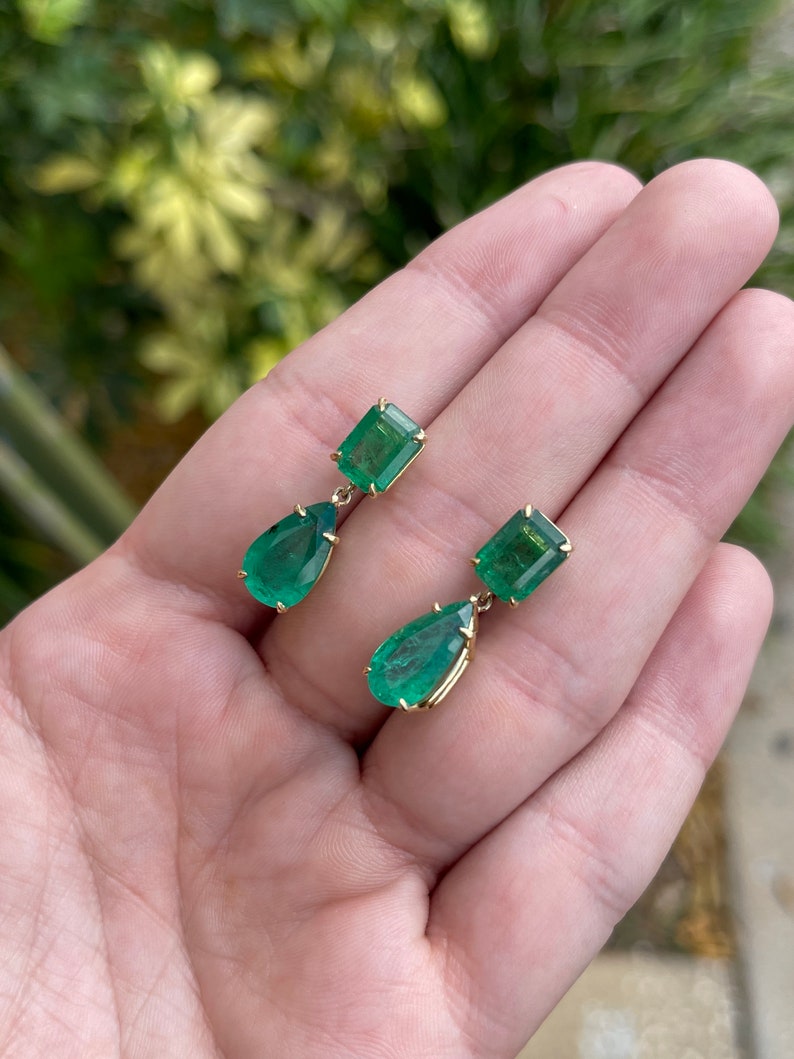 Colombian Emerald dangle earrings with 11.26tcw dark vivid green emeralds and pear cut design in 18K gold.