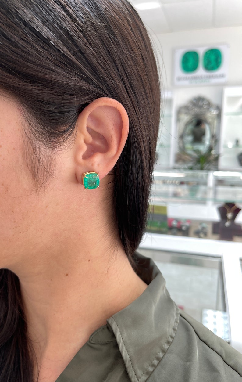 Colombian Emerald earrings with cushion-cut AAA emeralds in 18K gold, featuring four-claw prong settings and 11.80tcw total weight.