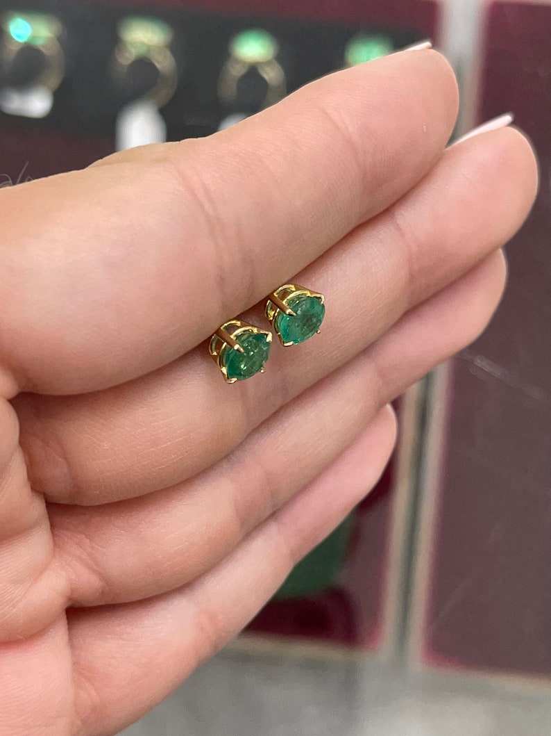 Natural emerald earrings with round cut, 2.0 tcw, dark green hue, four-prong setting, crafted in 14K gold by Colombian Emerald.