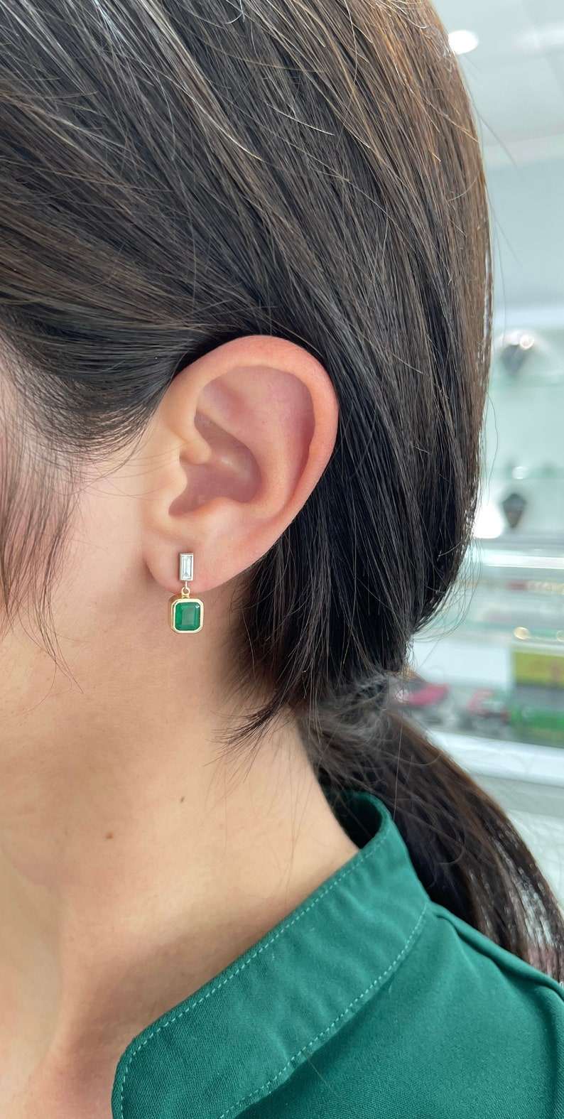 Deep green emerald and diamond bezel dangle earrings in 14K gold, featuring Colombian emeralds and elegant craftsmanship.