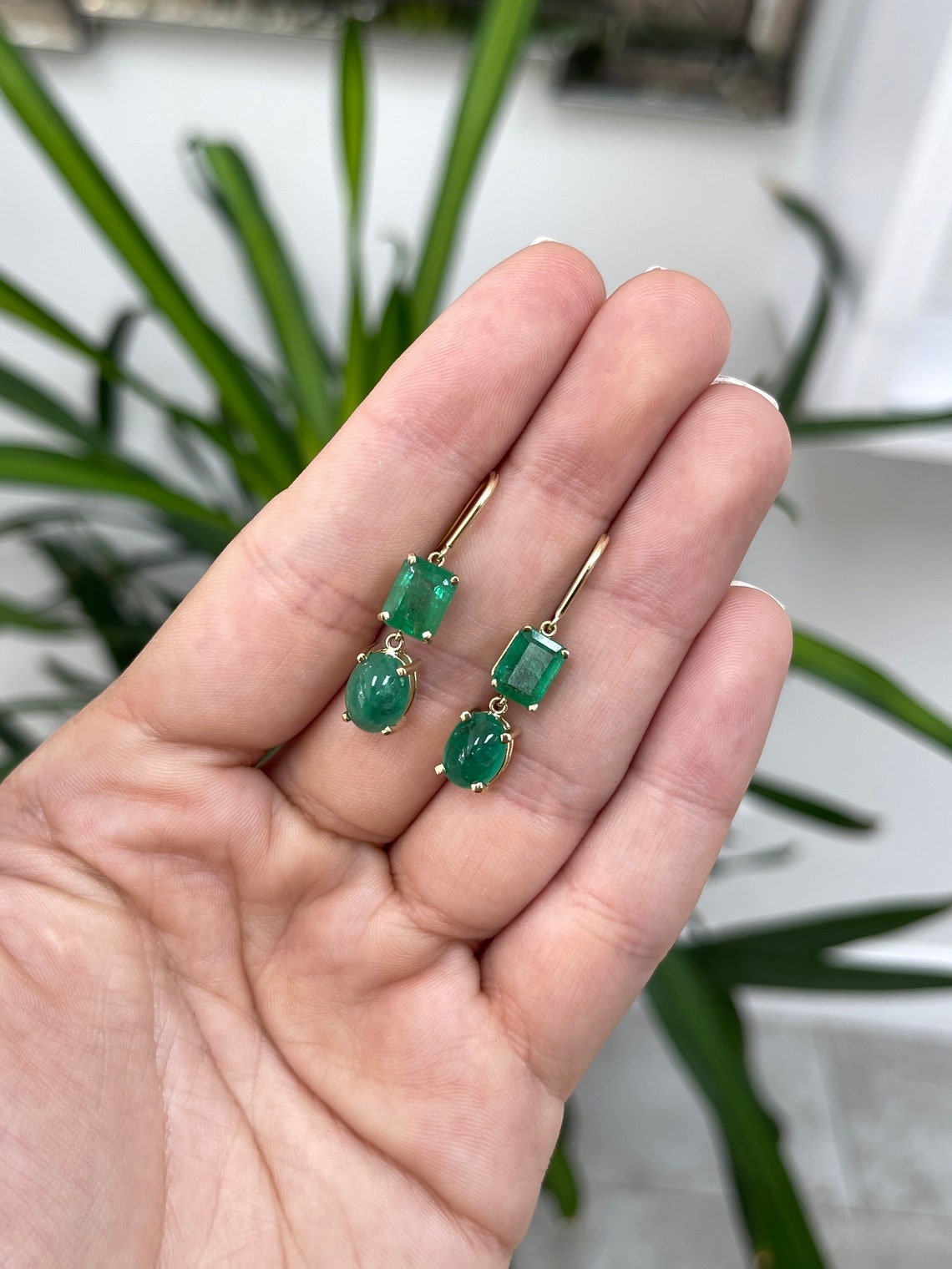 Colombian Emerald 8.45tcw forest green emerald cut and cabochon dangle earrings in 14K gold, showcasing elegant gemstone design.