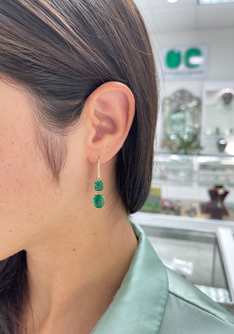 Dark emerald diamond accents dangle earrings in 18K gold, featuring fine quality Colombian emeralds with a total weight of 9.49 carats.