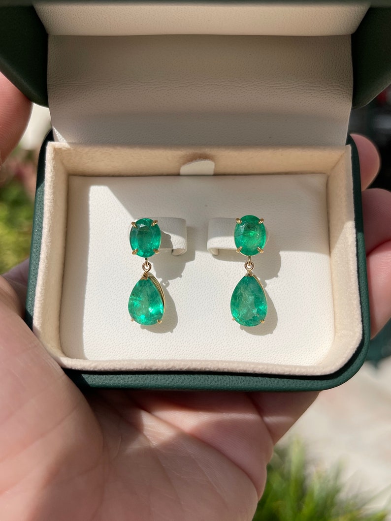 Colombian Emerald earrings with 9.78tcw dark green oval and pear-shaped emerald dangles in 18K gold, earth-mined and vibrant in color.