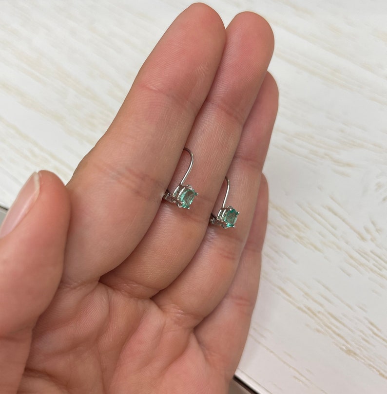 Petite 0.50ctw natural emerald oval cut lever back earrings in 14K gold from Colombian Emerald collection.