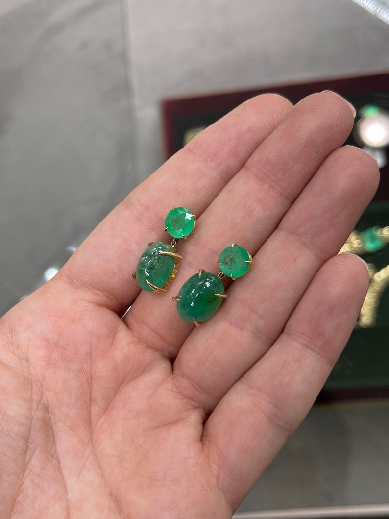 Colombian Emerald dangle earrings with round and oval cut yellow gold, featuring 16.82tcw of vibrant green emeralds.