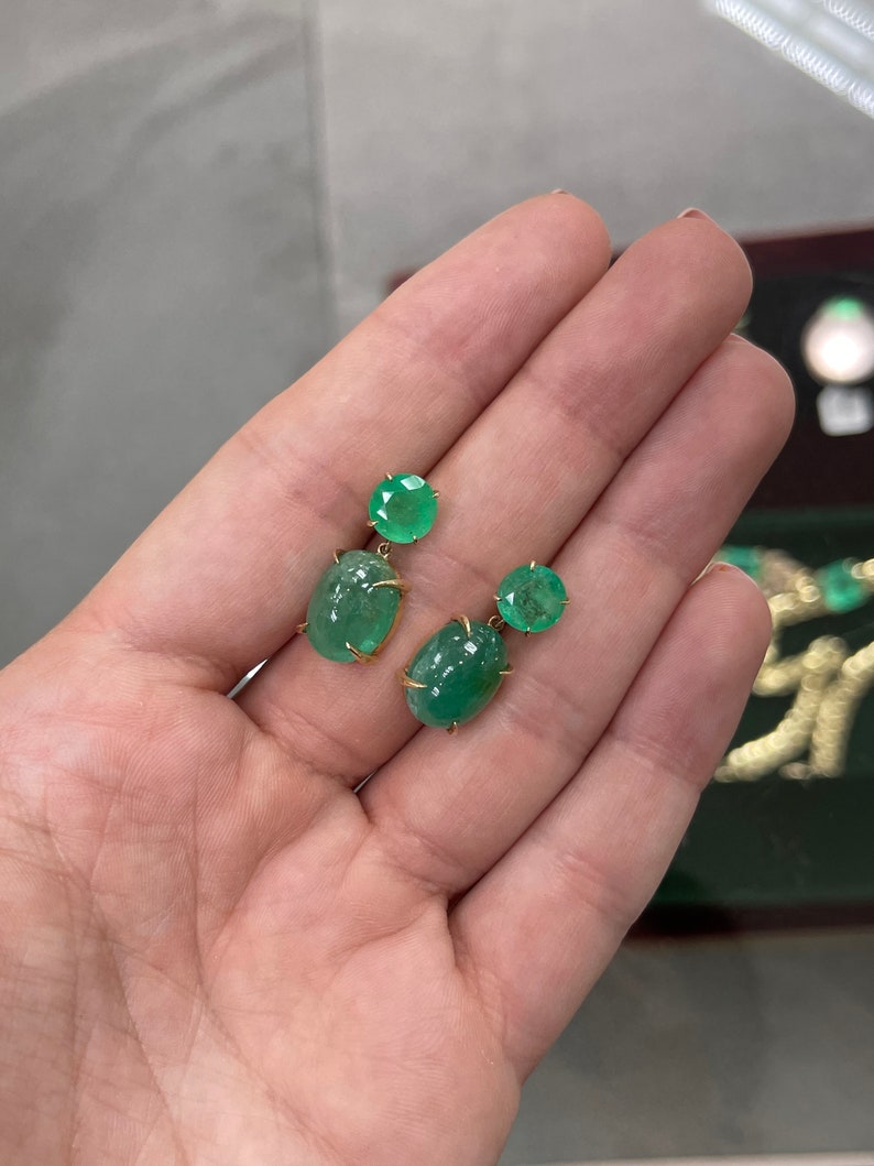 Colombian Emerald earrings with round and oval cut yellow gold dangles, featuring 16.82tcw of vibrant green emeralds.
