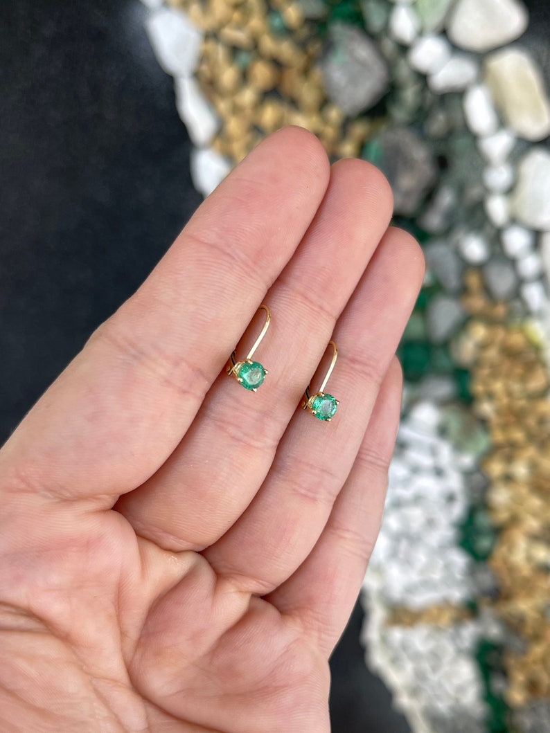 14K yellow gold emerald leverback earrings with round Colombian emeralds, showcasing elegant jewelry design.