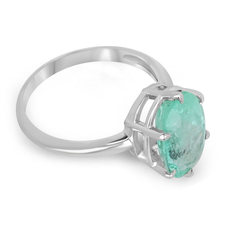 14K white gold emerald solitaire engagement ring with 3.55ct oval cut Colombian emerald and six prongs.