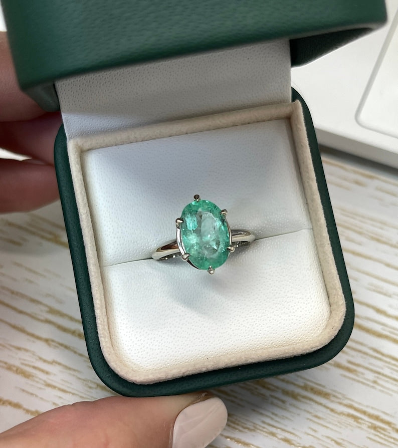 14K white gold emerald solitaire engagement ring with 3.55ct oval cut Colombian emerald and six prongs.