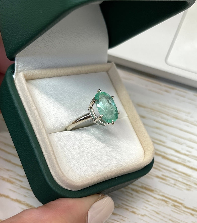 14K white gold emerald solitaire engagement ring with 3.55ct oval cut Colombian emerald and six-prong setting.