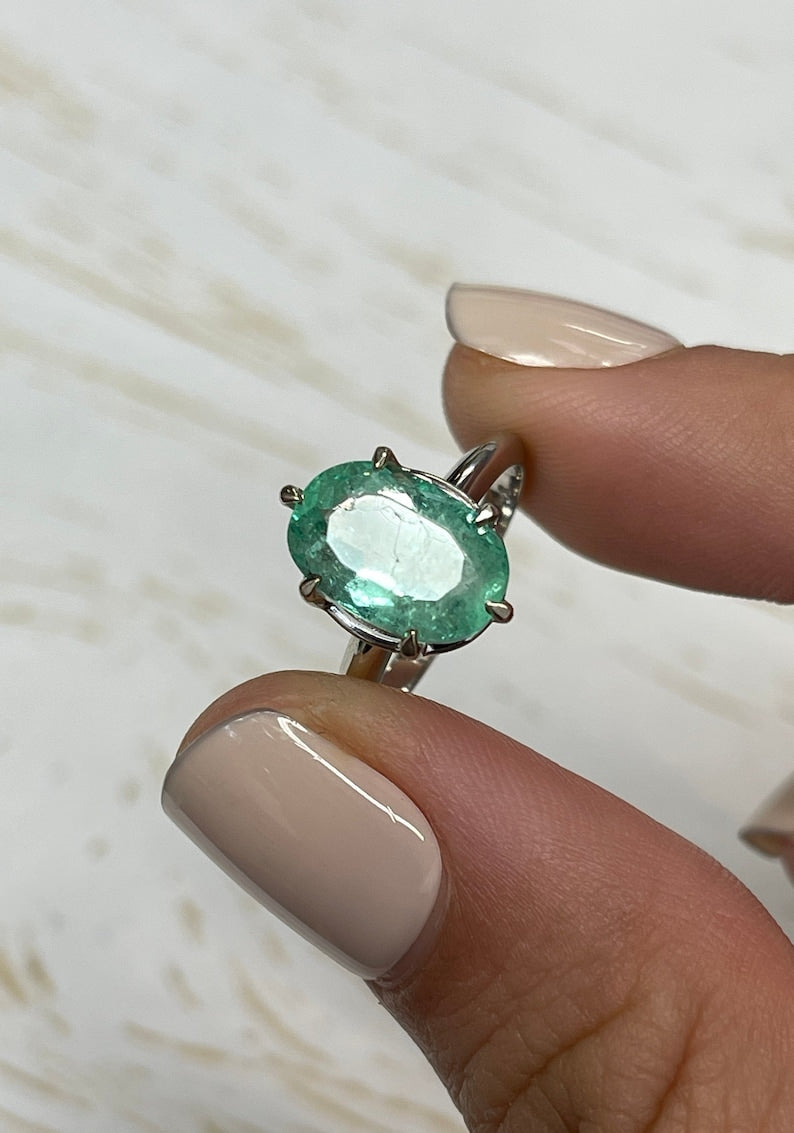 14K white gold emerald solitaire engagement ring with a 3.55ct oval cut Colombian emerald and 6-prong setting.