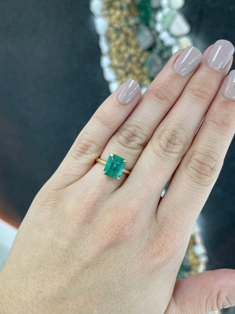Colombian Emerald 4.10 carat natural emerald cut solitaire yellow gold engagement ring with four prongs and half bezel setting