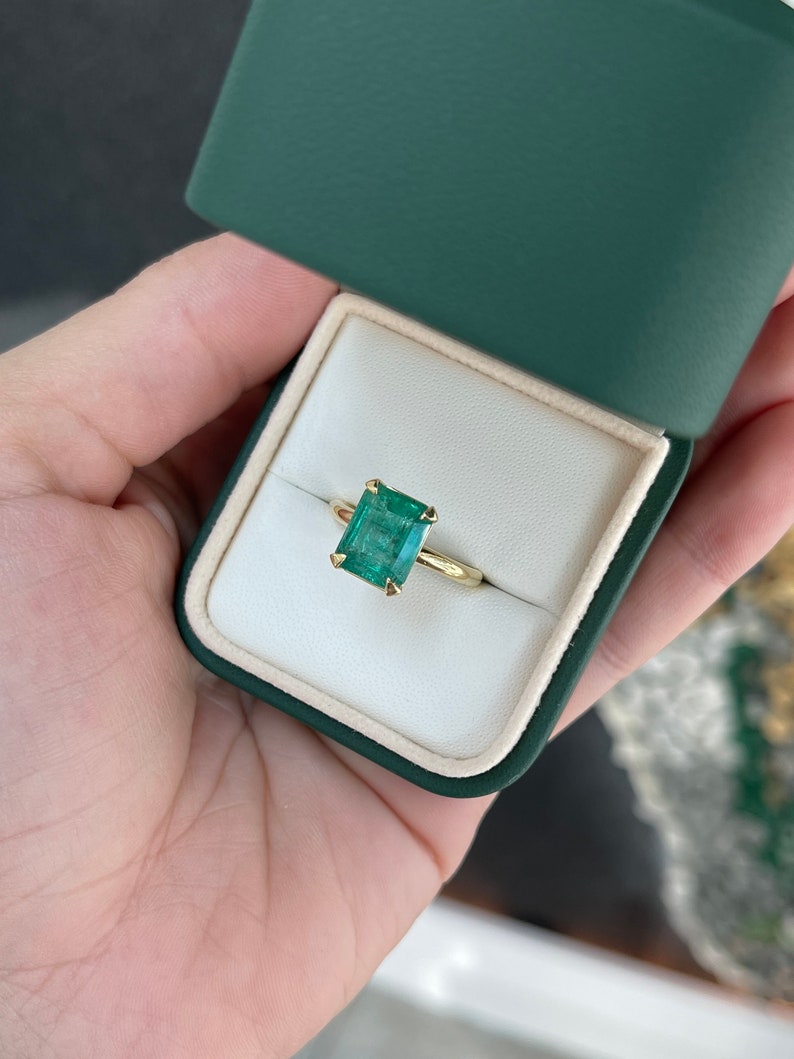 Colombian Emerald 4.10 carat natural emerald cut solitaire engagement ring in 18K yellow gold with four prongs and half-bezel setting