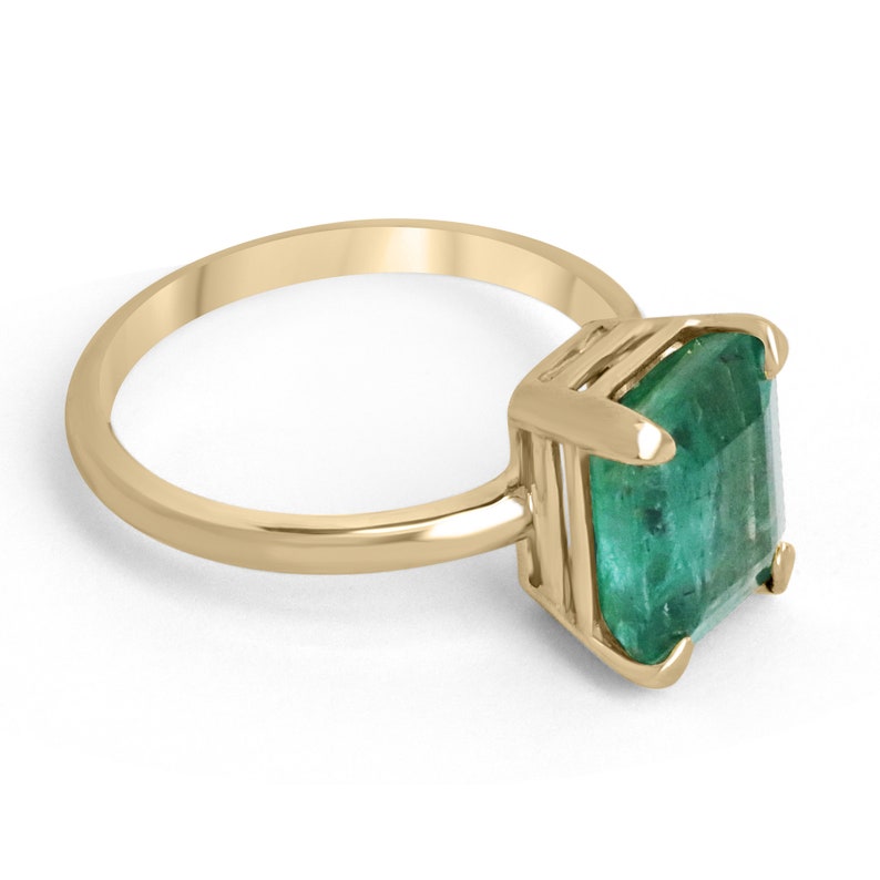 Colombian Emerald 4.10 carat natural emerald cut solitaire engagement ring with four prongs in yellow gold.