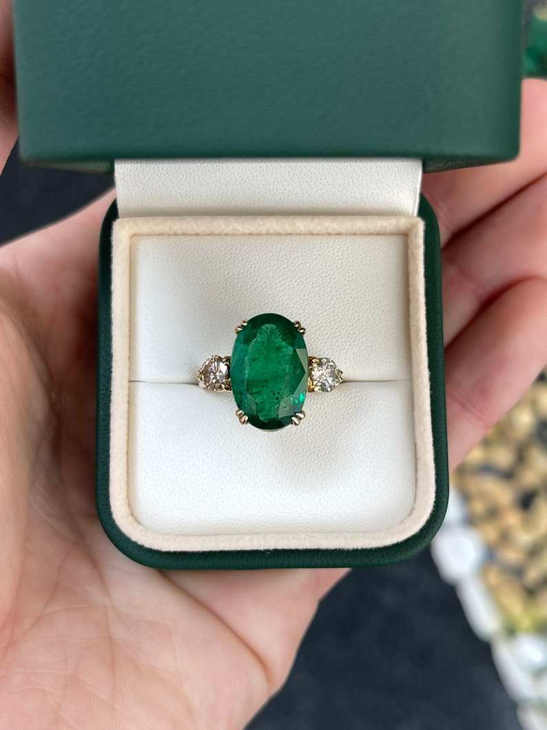 Dark green oval emerald and round diamond 3-stone engagement ring with 14K gold setting by Colombian Emerald.
