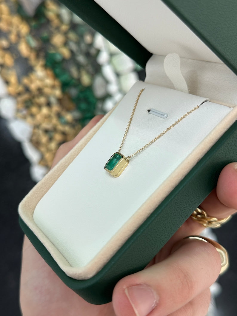 14K gold emerald cut necklace with lush green bezel-set emerald pendant on adjustable chain, Colombian Emerald jewelry.