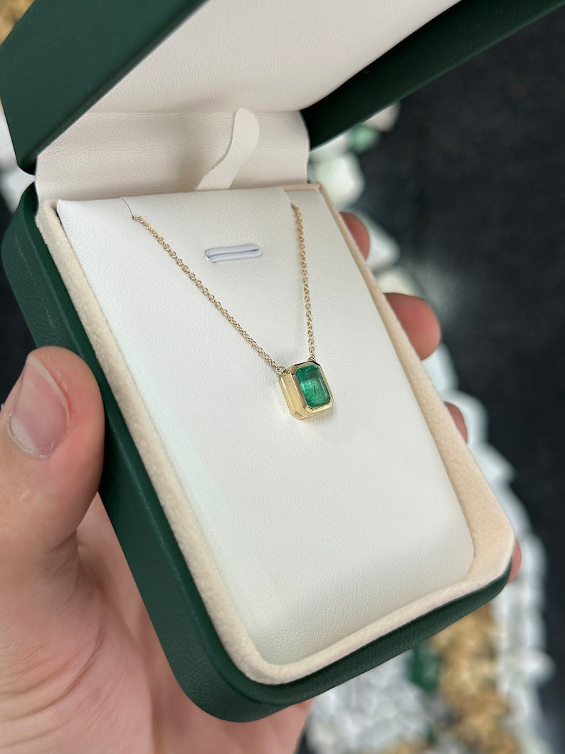 Medium green emerald cut bezel set necklace with 1.90ct Colombian emerald on 14K gold adjustable chain.