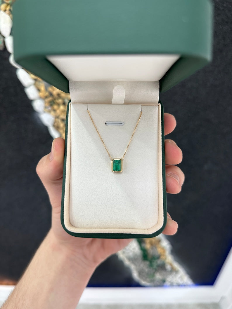 14K gold emerald-cut green pendant necklace with adjustable chain, featuring bezel-set Colombian emerald for elegant style.