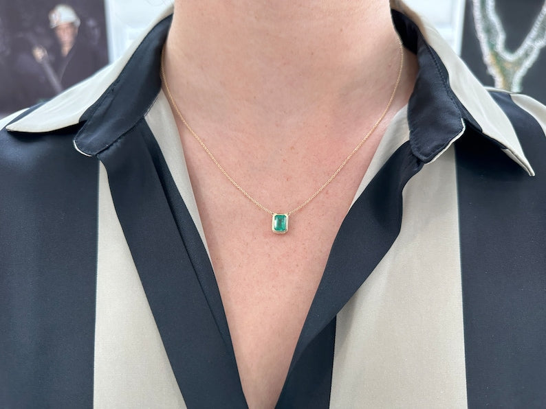 14K gold emerald cut necklace with lush green bezel set emerald, adjustable chain, Colombian Emerald brand, jewelry accessory.