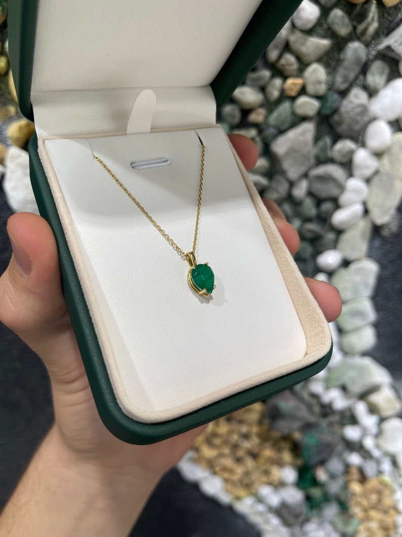 Natural 1.54 carat Colombian emerald inverted pear cut solitaire pendant in 14K gold, showcasing a vibrant green gemstone.