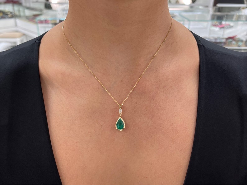 Colombian Emerald teardrop pendant necklace with marquise diamond accents, natural pear-cut emerald, 14K gold bezel setting.