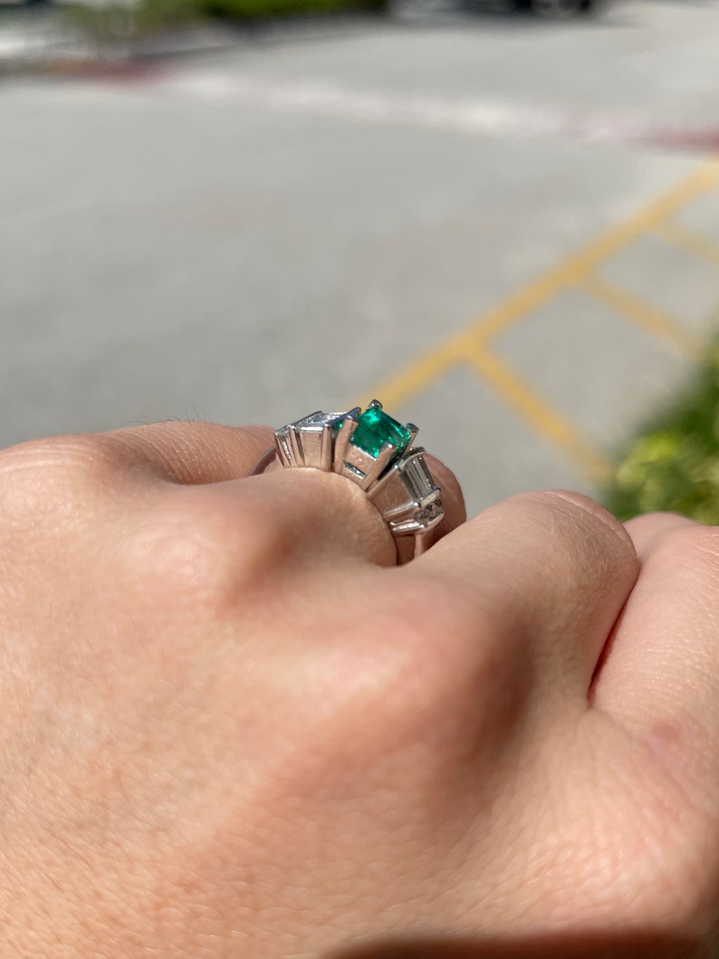 Vivid dark green emerald Asscher cut ring with diamond accents in platinum, Colombian Emerald brand engagement ring image.
