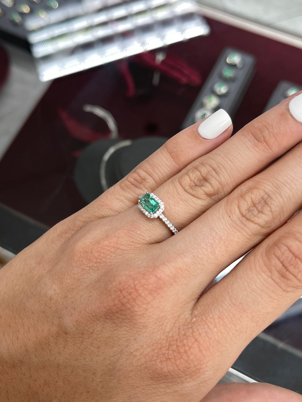 14K gold engagement ring with 1.25tcw emerald cut emerald and diamond halo, designed by Colombian Emerald.