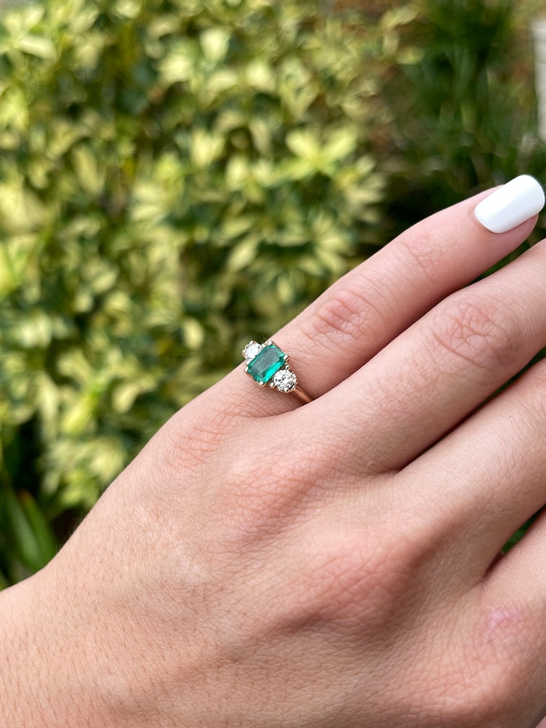 Dark bluish-green emerald and round diamonds 3-stone engagement ring in 14K gold by Colombian Emerald, featuring a detailed side view.