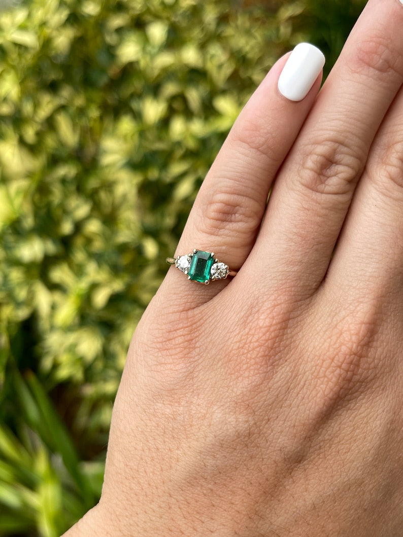 Dark bluish-green emerald and round diamonds 3-stone engagement ring in 14K gold by Colombian Emerald, showcasing the gemstones and band.