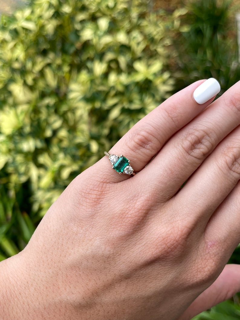 Dark bluish-green emerald and round diamonds 3-stone engagement ring in 14K gold, featuring Colombian Emerald brand.