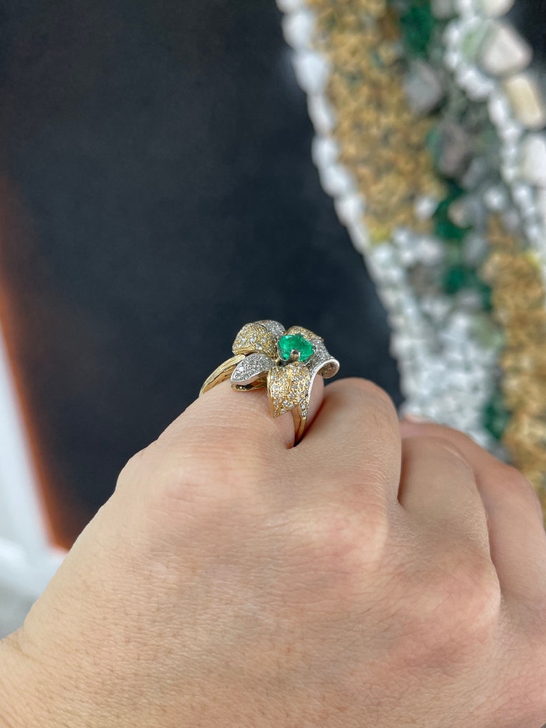 Ladies 14K gold emerald and diamond cluster floral cocktail ring with round cut stones and leaf design, featuring Colombian emeralds.