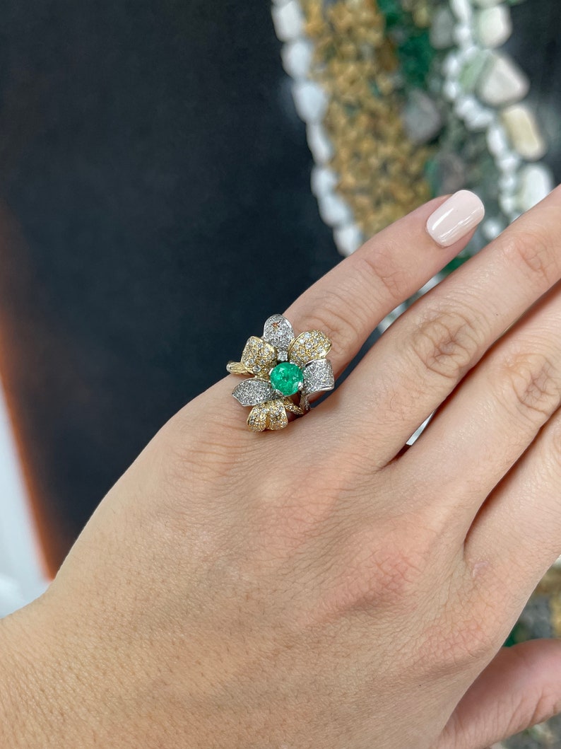 Ladies 14K gold emerald and diamond cluster floral cocktail ring with round cut stones and leaf design by Colombian Emerald.