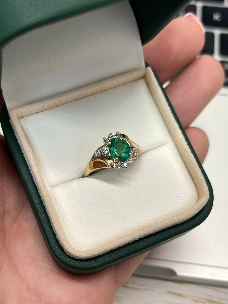 Ladies emerald ring featuring a 1.81tcw dark green oval cut emerald with diamond accents in 14K gold by Colombian Emerald.