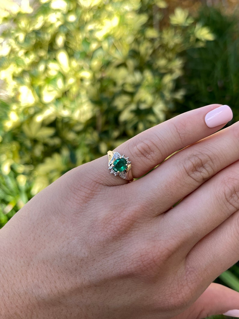Ladies emerald ring featuring a 1.81tcw dark green oval cut emerald with diamond accents in a 14K gold setting, by Colombian Emerald.