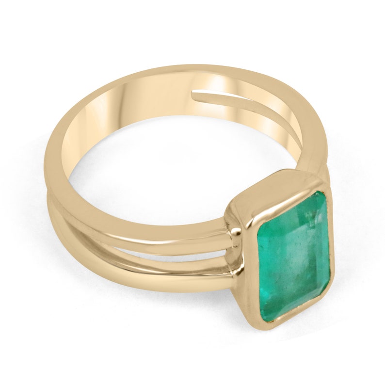Colombian Emerald ladies ring with 2.05ct vivid green emerald cut solitaire in 14K gold, featuring a split shank design.
