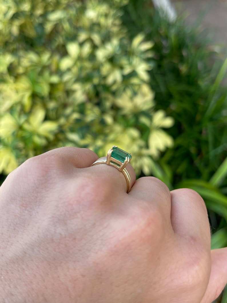 Ladies emerald ring with 2.68ct Colombian emerald, 18K gold, east-west cut, double claw prong, split shank design.