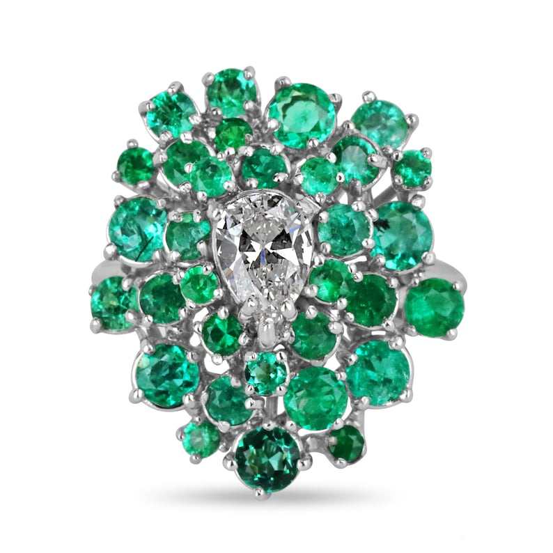 Ladies emerald cluster ring featuring teardrop-shaped diamonds and Colombian emeralds set in 14K white gold.