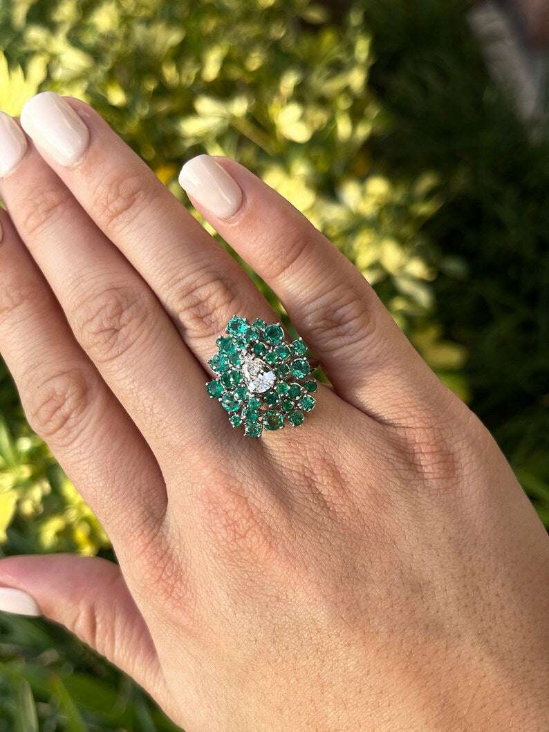 Ladies 14K white gold teardrop diamond and emerald cluster statement ring with Colombian emeralds and sparkling diamonds.