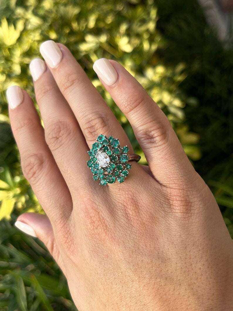 Ladies emerald statement ring featuring teardrop diamonds and Colombian emeralds in 14K white gold.