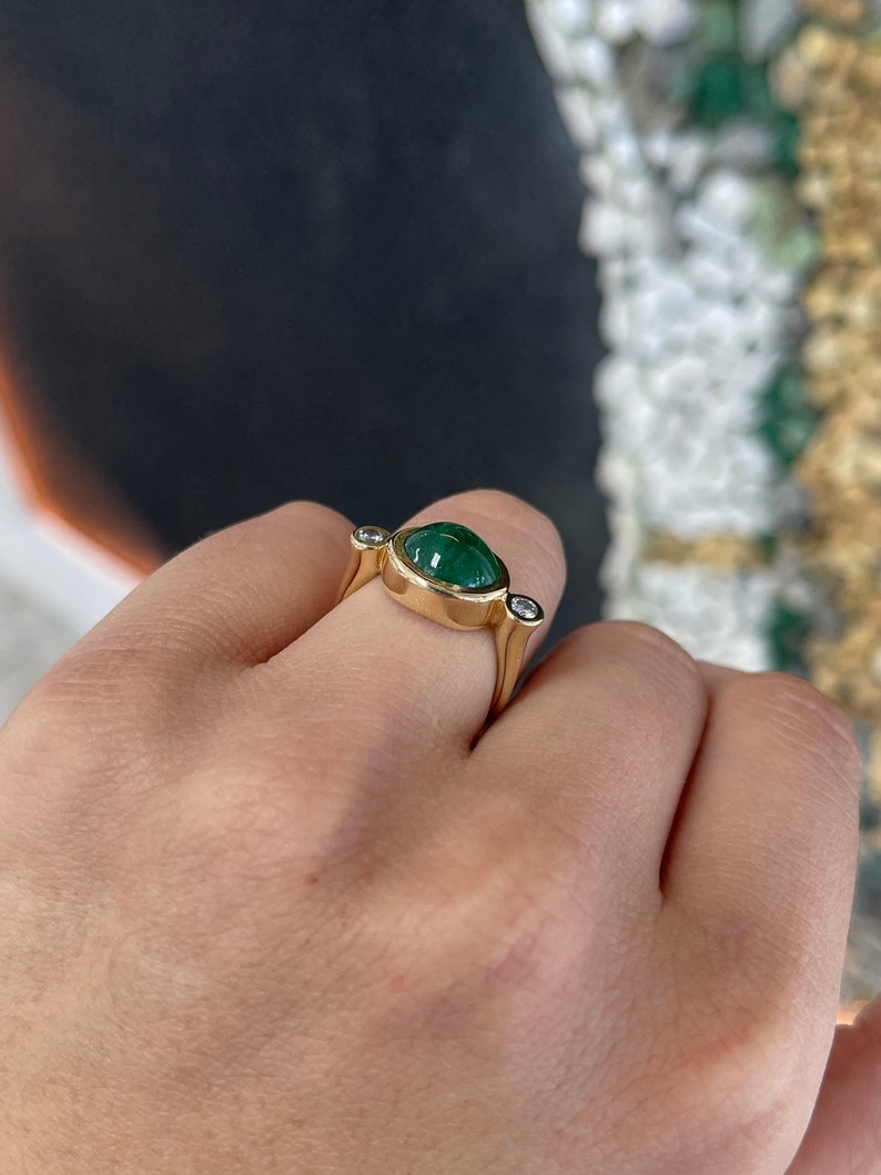 Ladies emerald ring featuring a 4.50 tcw oval dark green emerald with diamond accents in 14K gold, Colombian Emerald brand.