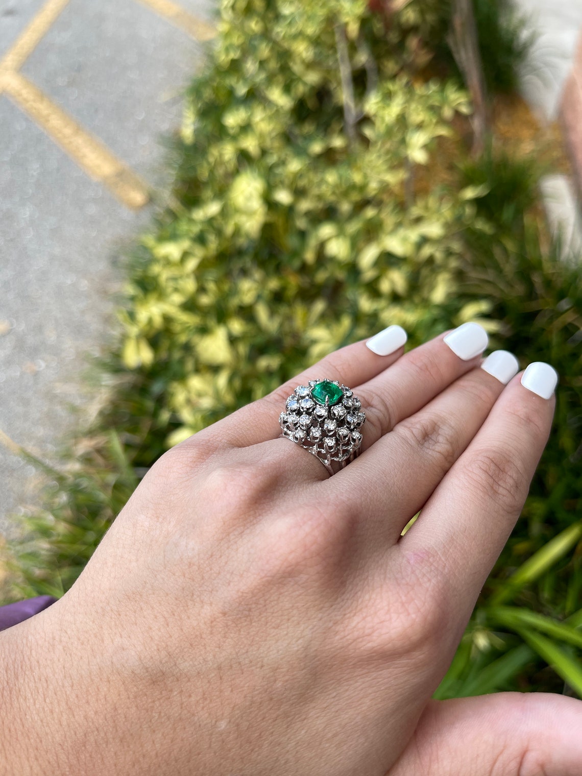 Ladies emerald ring featuring a 5.0tcw cushion-cut Colombian emerald and vintage diamond accents in 14K white gold.