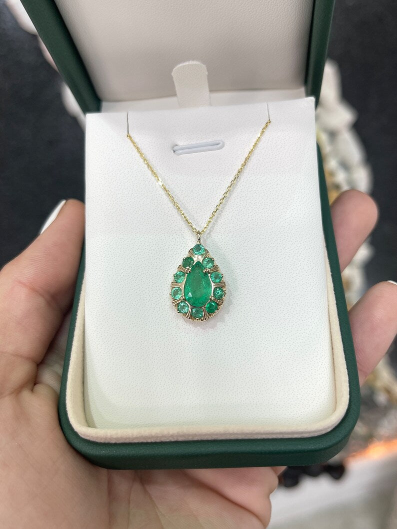 14K gold pendant necklace with natural emeralds, featuring pear and round cut multi-gemstones in a prong setting.