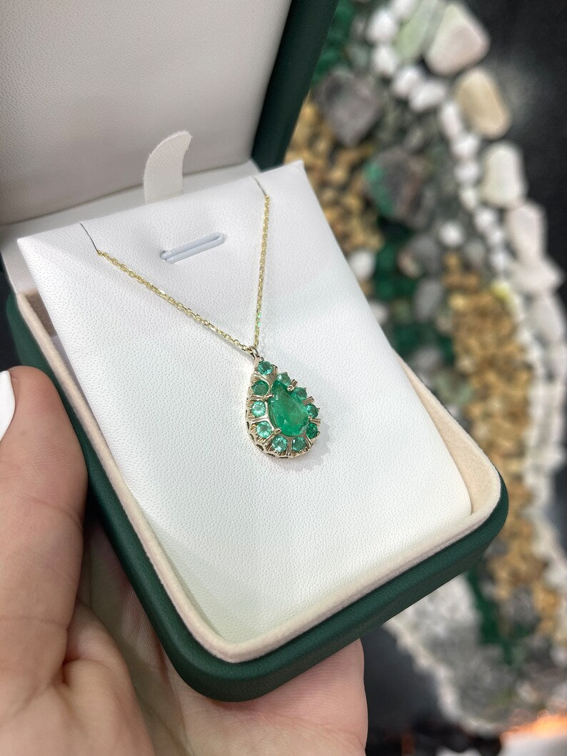 14K gold pendant necklace with natural emeralds, featuring pear and round cut multi-gemstones and prong setting.