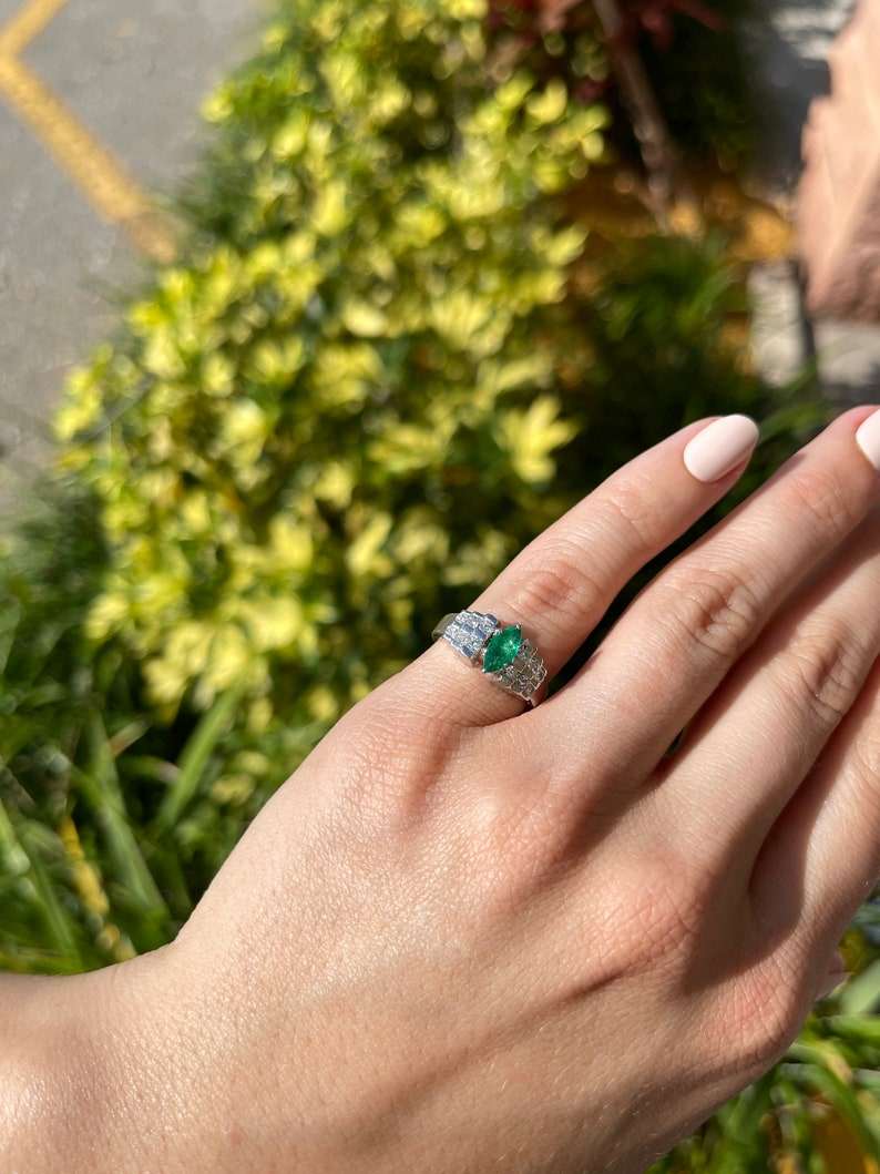 Semi-transparent platinum cocktail ring featuring a 0.88 carat Colombian emerald marquise diamond, elegant jewelry design.